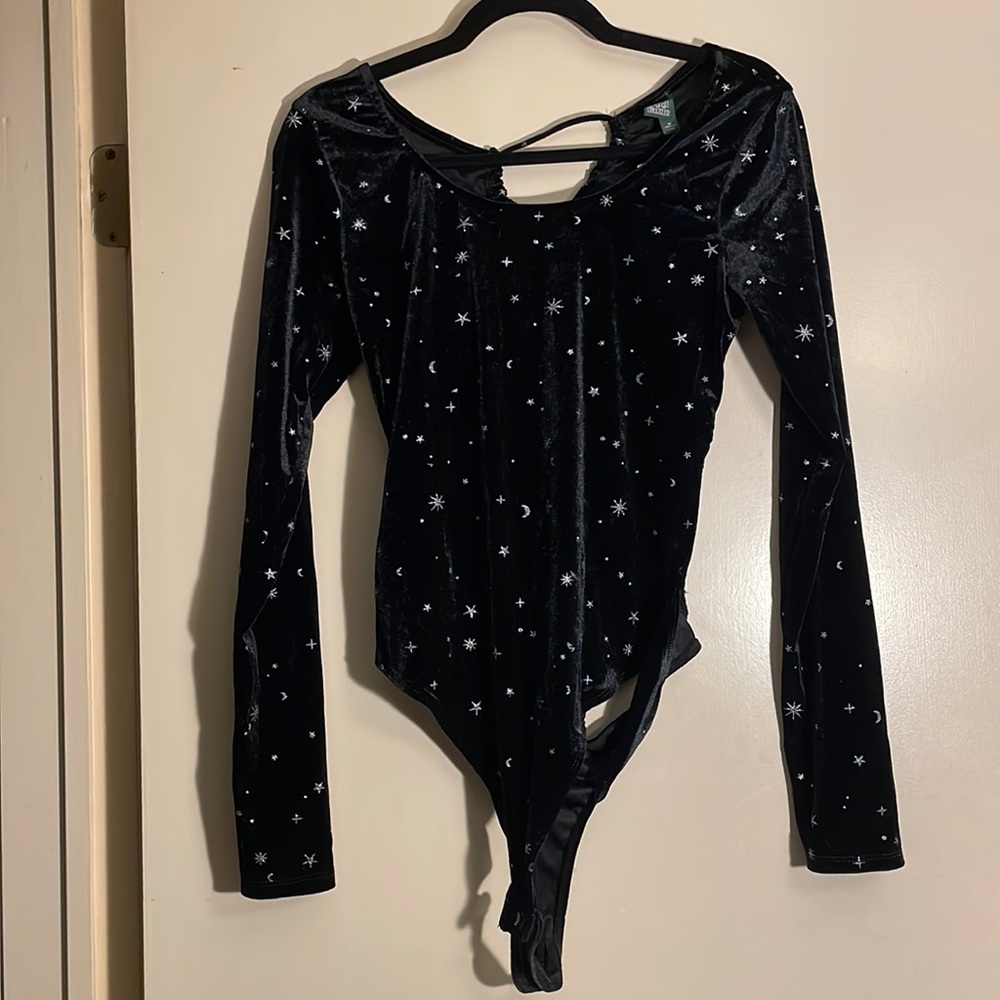 Silver stars and moons on black body suit